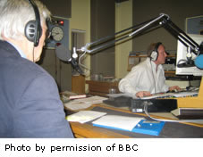 A picture of Patrick Tansey in a radio station studio on air